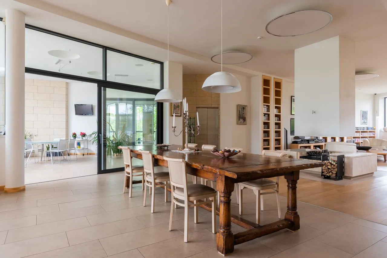 Long timber dining table connecting the shared rooms