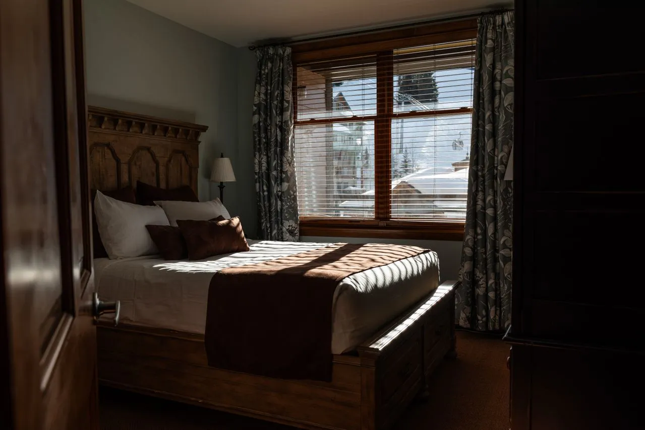 Timber bedroom with daylight crossing the bed