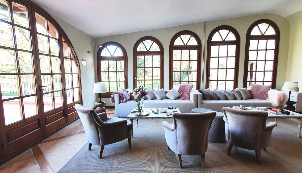 Cedar House sitting room gathered around tall garden windows