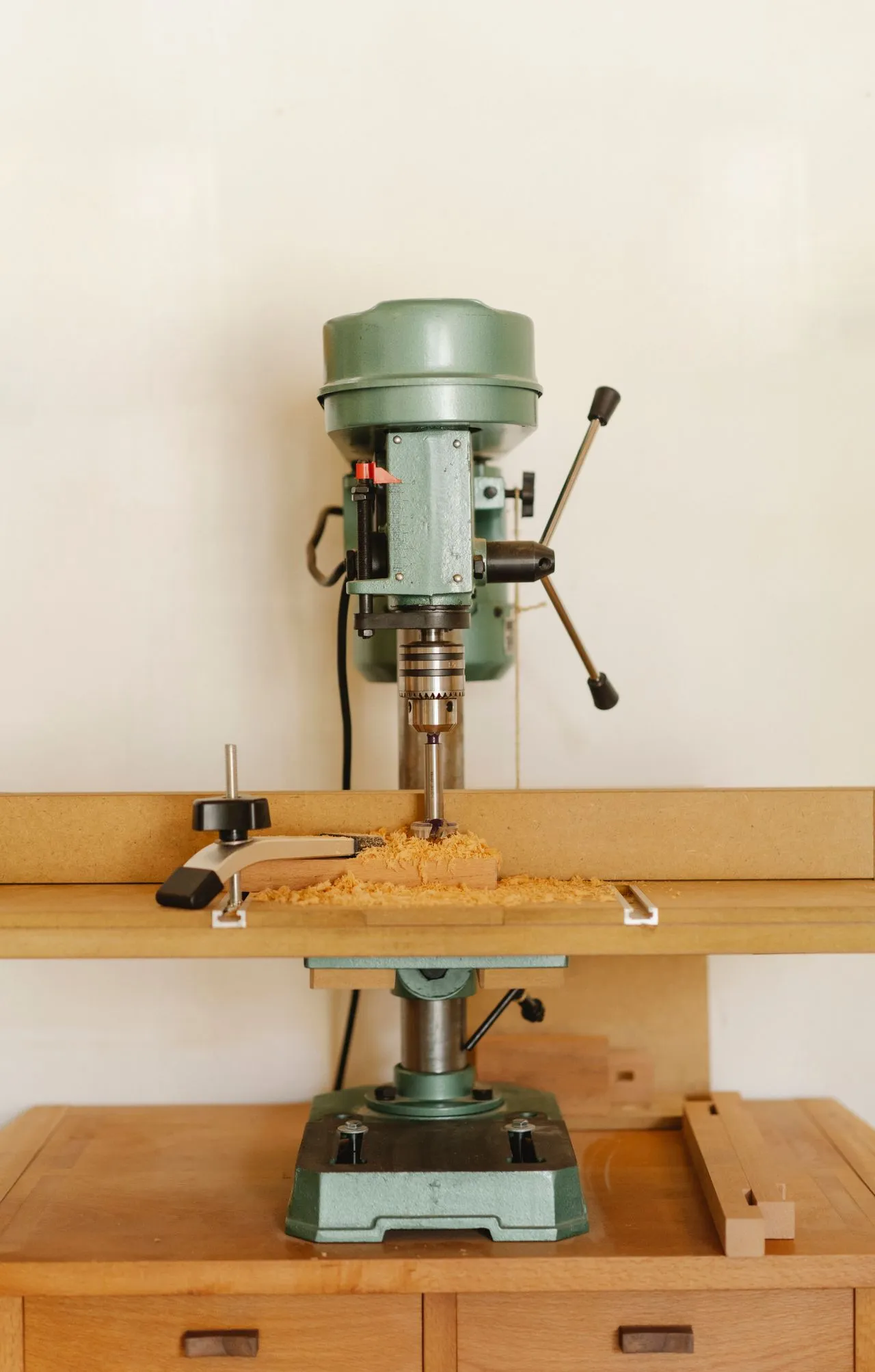 Workshop drill on a timber work surface